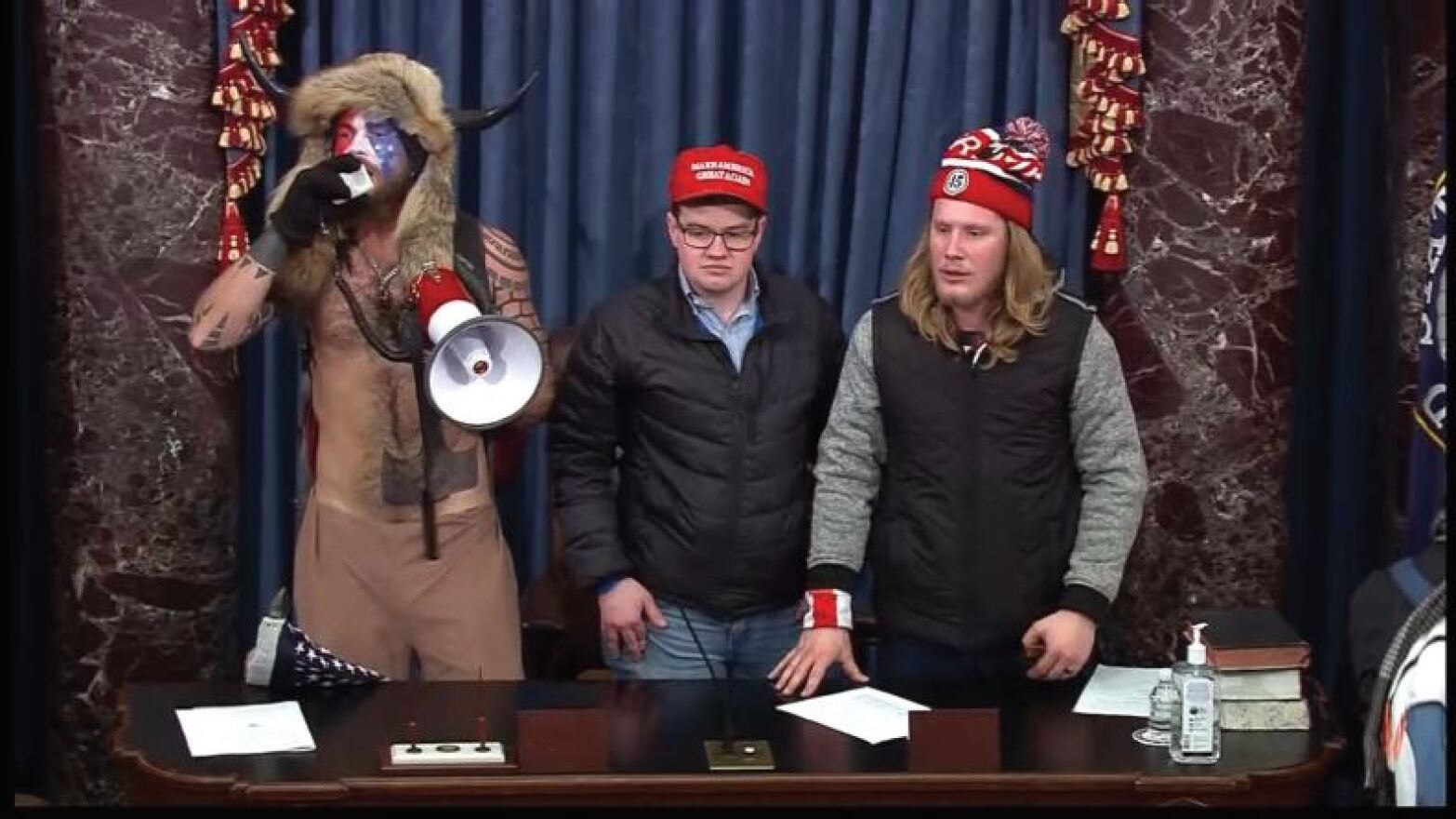 A screen grab from footage of the Senate chamber depicts Richard T. Crosby Jr. on the Senate dais (center) on Jan. 6, 2021, shortly after the evacuation of Vice President Mike Pence and senators from the chamber.